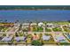 Waterfront home featuring solar panels, a well-manicured lawn, and mature trees, situated near docks at 863 Riverside Dr, Ormond Beach, FL 32176