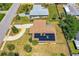 Aerial view of a home with solar panels on the roof and a circular driveway in a residential neighborhood at 863 Riverside Dr, Ormond Beach, FL 32176