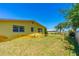 Wide backyard featuring a well-maintained lawn, and the house exterior with multiple windows at 863 Riverside Dr, Ormond Beach, FL 32176