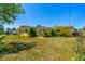 Large backyard with a screened in porch, mature trees, and a well maintained lawn at 863 Riverside Dr, Ormond Beach, FL 32176