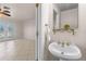 The half bathroom features a sink with a mirror, with a view into a living room at 863 Riverside Dr, Ormond Beach, FL 32176