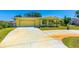Inviting single-story home with attached garage, vibrant yellow paint, and well-maintained lawn at 863 Riverside Dr, Ormond Beach, FL 32176