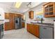 Well-lit kitchen featuring stainless steel appliances, wooden cabinets and tile flooring at 863 Riverside Dr, Ormond Beach, FL 32176
