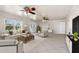 Bright living room with neutral decor, tile floors, ceiling fans, and plenty of natural light at 863 Riverside Dr, Ormond Beach, FL 32176