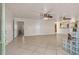 Bright and open living room featuring tile flooring, ceiling fans, and access to the kitchen at 863 Riverside Dr, Ormond Beach, FL 32176