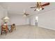 Large living room with tile flooring and ceiling fans that connects to a half bathroom at 863 Riverside Dr, Ormond Beach, FL 32176