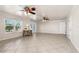 Spacious living room featuring tile flooring, ceiling fans, and natural light from the window and french doors at 863 Riverside Dr, Ormond Beach, FL 32176