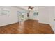 Bright living room featuring wood floors, large windows, and sliding glass doors to the backyard at 863 Riverside Dr, Ormond Beach, FL 32176