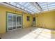 Enclosed patio with ceiling and outdoor access through glass sliding doors at 863 Riverside Dr, Ormond Beach, FL 32176