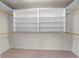 Spacious walk-in closet with custom built in shelving and clothing rods providing ample storage solutions at 863 Riverside Dr, Ormond Beach, FL 32176