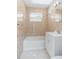 Bright bathroom features tile walls and floor, a shower-tub combination, and white vanity at 954 Chippendale St, Deltona, FL 32725