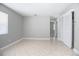 Spacious bedroom with tile flooring, neutral paint, and closet space at 954 Chippendale St, Deltona, FL 32725