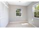 Bright bedroom featuring two windows, ample closet space, and tile flooring at 954 Chippendale St, Deltona, FL 32725