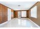 Cozy bonus room with wood paneling, tile floors, and a door to the exterior at 954 Chippendale St, Deltona, FL 32725