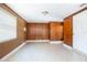 Spacious living room with wood paneling, large window, and tile flooring providing lots of natural light at 954 Chippendale St, Deltona, FL 32725