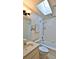 Bright bathroom features a vanity, toilet, and a shower/tub combo with white tiling and a skylight at 1 Fox Hollow Dr, Ormond Beach, FL 32174