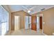 Bedroom with closet and bookshelves, window with blinds, and ceiling fan at 1 Fox Hollow Dr, Ormond Beach, FL 32174