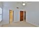 Bedroom featuring a walk-in closet, neutral carpet and white walls at 1 Fox Hollow Dr, Ormond Beach, FL 32174