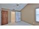 Vaulted bedroom with closet access, bright window, and ceiling fan at 1 Fox Hollow Dr, Ormond Beach, FL 32174