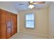 Cozy bedroom featuring a window with blinds and closet with wooden doors at 1 Fox Hollow Dr, Ormond Beach, FL 32174