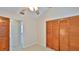 Bedroom featuring a closet with wooden doors and view into bathroom at 1 Fox Hollow Dr, Ormond Beach, FL 32174