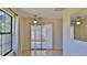 Bright dining area with tile flooring, sliding glass doors, and a large window for natural light at 1 Fox Hollow Dr, Ormond Beach, FL 32174