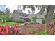 Charming two-story brick home with mature landscaping, lush lawn and a two car garage at 1 Fox Hollow Dr, Ormond Beach, FL 32174