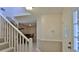 Inviting foyer featuring a staircase and view into the dining room at 1 Fox Hollow Dr, Ormond Beach, FL 32174
