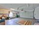 Spacious garage features a large door, a ceiling fan, overhead storage and a rug to provide comfort at 1 Fox Hollow Dr, Ormond Beach, FL 32174