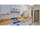A kitchen with white cabinetry, a stove, and a range hood at 1 Fox Hollow Dr, Ormond Beach, FL 32174