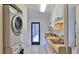 Bright laundry area with side-by-side washer and dryer near the entrance to the kitchen at 1 Fox Hollow Dr, Ormond Beach, FL 32174