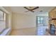 Comfortable living room featuring a stone fireplace, ceiling fan and large window at 1 Fox Hollow Dr, Ormond Beach, FL 32174