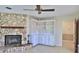 Cozy living room with a stone fireplace, built-in shelves and cabinets at 1 Fox Hollow Dr, Ormond Beach, FL 32174