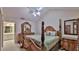 Spacious main bedroom featuring high ceilings, ceiling fan, and decorative wood furniture at 1 Fox Hollow Dr, Ormond Beach, FL 32174