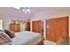 Comfortable main bedroom with high ceilings, wood furnishings, and closet space at 1 Fox Hollow Dr, Ormond Beach, FL 32174