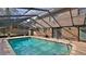 Enclosed pool with brick pavers and a screened enclosure, perfect for relaxing and entertaining at 1 Fox Hollow Dr, Ormond Beach, FL 32174