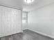 Bedroom featuring gray wood floors, light-colored walls, a closet, and a window to let in natural light at 102 Judges Ln, Port Orange, FL 32129