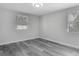 Bedroom with gray wood floors, light-colored walls, and two windows at 102 Judges Ln, Port Orange, FL 32129
