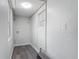 Neutral laundry room featuring gray wood-look floors, natural light, and washer/dryer hookups at 102 Judges Ln, Port Orange, FL 32129