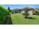 Lush backyard with green grass, mature trees, and well-maintained privacy hedges at 1088 Avery Meadows Way, Deland, FL 32724