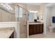 Elegant bathroom featuring a walk-in shower with glass doors and granite countertops at 1088 Avery Meadows Way, Deland, FL 32724