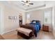 Cozy bedroom with a tray ceiling, hardwood floors, and a walk-in closet at 1088 Avery Meadows Way, Deland, FL 32724