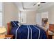 Bright bedroom with a tray ceiling, plantation shutters, and hardwood floors at 1088 Avery Meadows Way, Deland, FL 32724