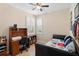 Cozy bedroom with a desk, plantation shutters, and natural light at 1088 Avery Meadows Way, Deland, FL 32724