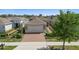 Aesthetic single story house with a brick driveway, well-maintained lawn, and neutral color palette at 1088 Avery Meadows Way, Deland, FL 32724