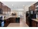 Well-equipped kitchen with dark wood cabinetry, granite counters, and stainless steel appliances at 1088 Avery Meadows Way, Deland, FL 32724
