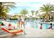 Resort-style pool area with palm trees, lounge chairs, and a sunny atmosphere at 1088 Avery Meadows Way, Deland, FL 32724