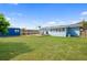 Spacious backyard with shed, deck, and ample grass space for outdoor activities at 111 Claire Ter, Daytona Beach, FL 32118