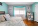 Serene bedroom featuring wood floors, neutral color walls, and natural light for a tranquil and inviting atmosphere at 111 Claire Ter, Daytona Beach, FL 32118
