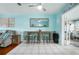 Bright dining area featuring tile floors, blue walls, beach decor, and plenty of seating at 111 Claire Ter, Daytona Beach, FL 32118